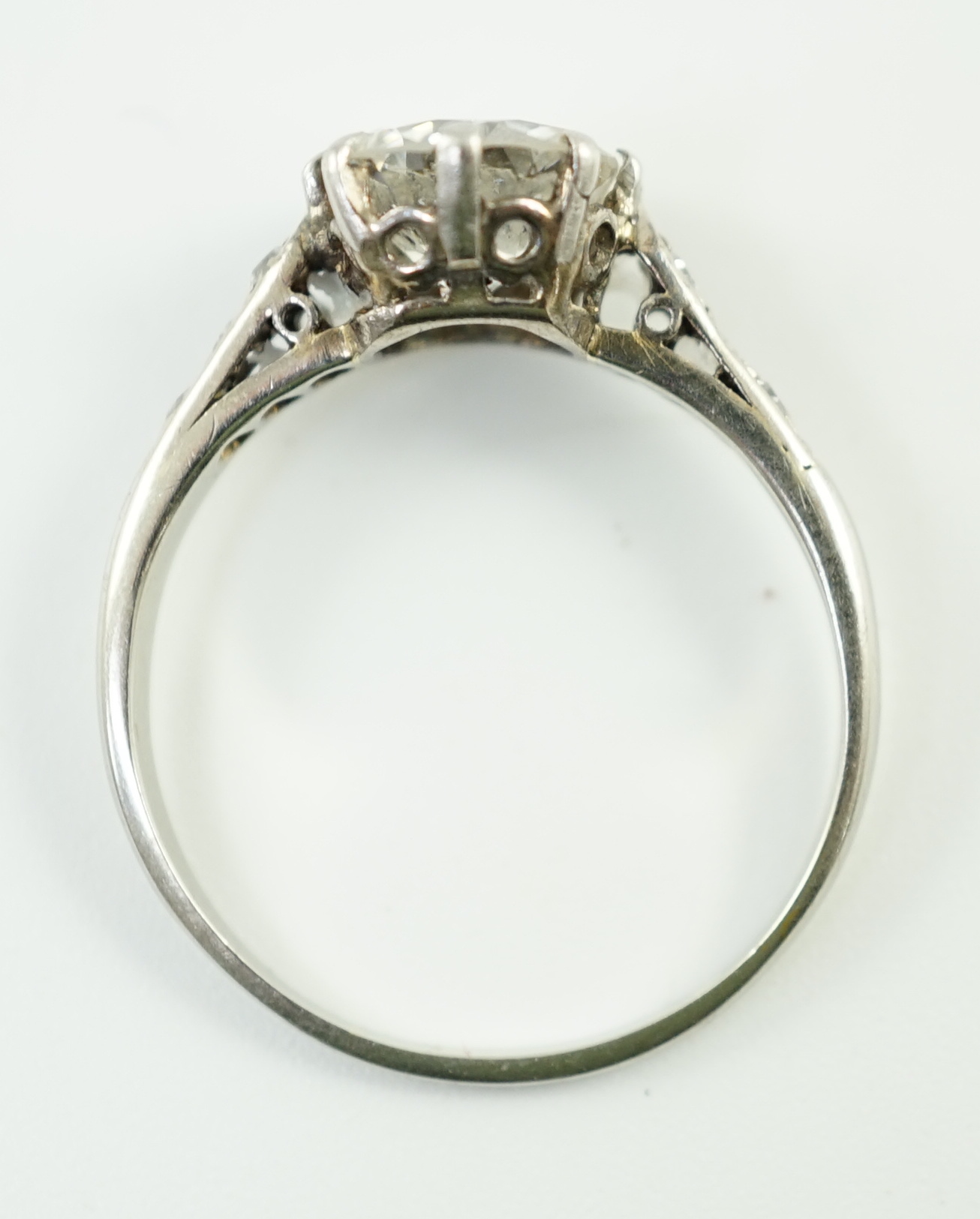 A platinum and single stone diamond ring, with diamond set shoulders